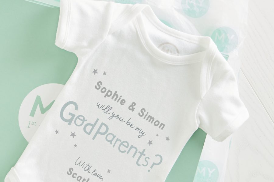 White baby bodysuit with text on front