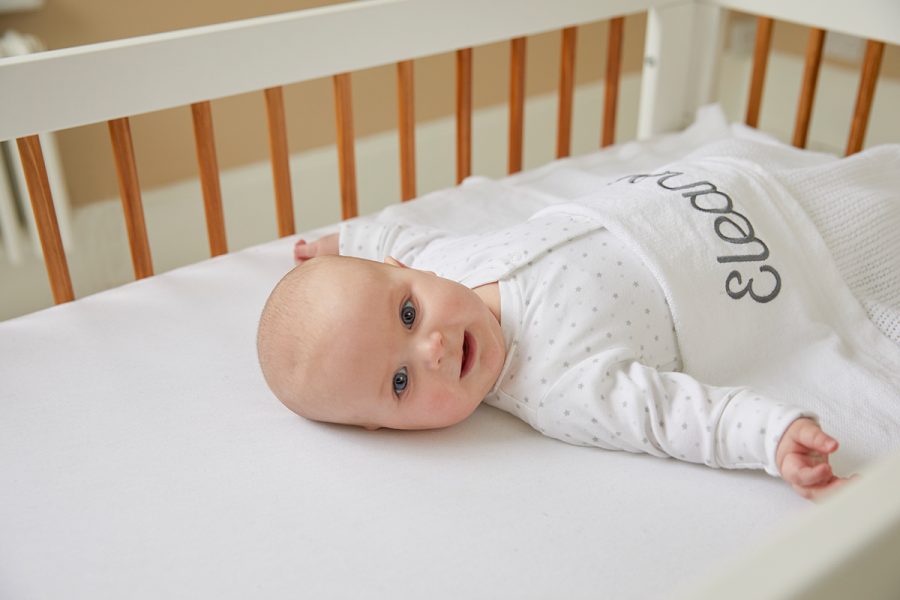 baby laying in cot