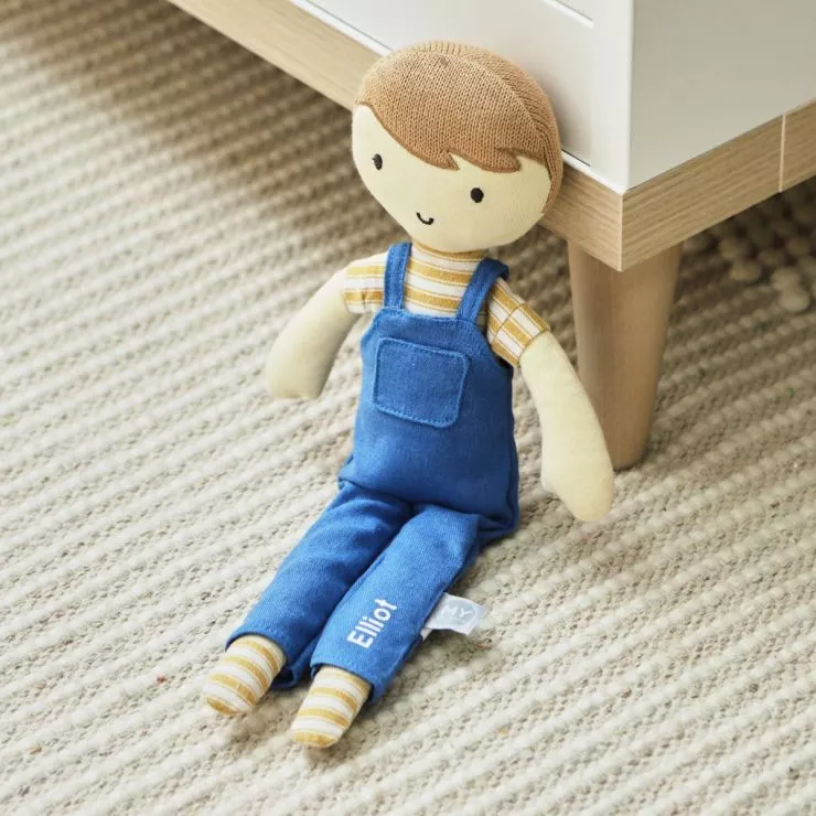 Toy doll sat on carpet