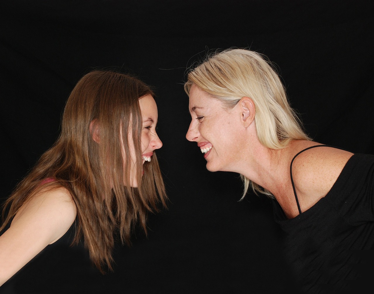 girl and woman facing each other whilst laughing